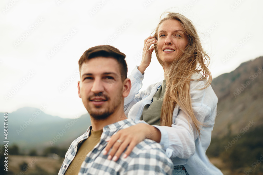 Happy couple man and woman tourists in mountains Happy couple man and woman tourists in mountains