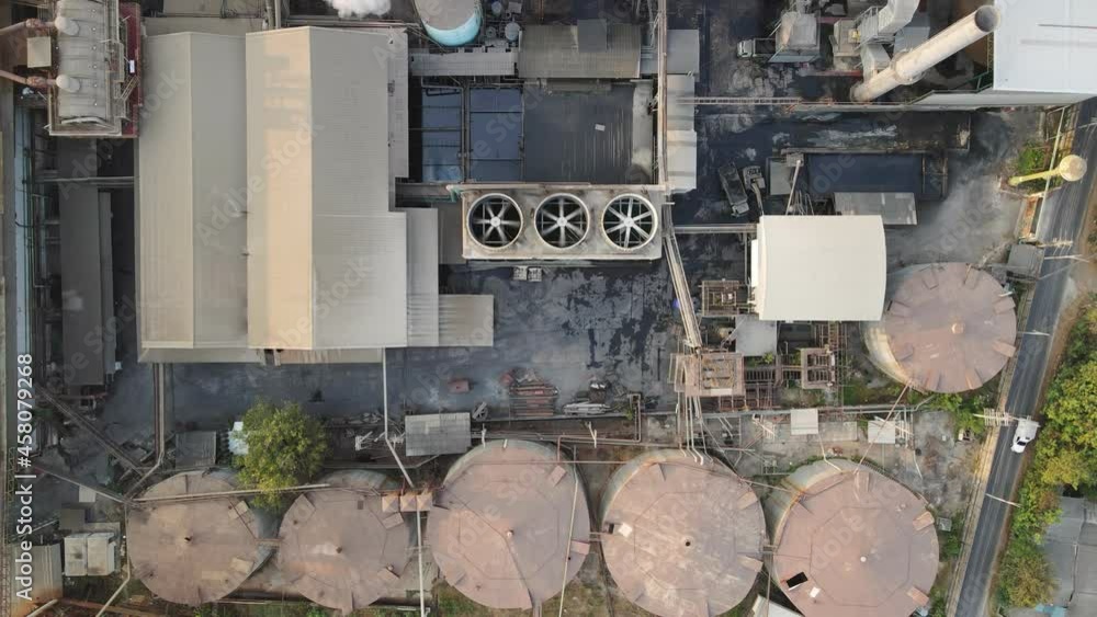 Ethanol industrial or biofuel refinery processing factory with smoke from chimney, storage tanks and warehouse Ethanol industrial or biofuel refinery processing factory with smoke from chimney, storage tanks and warehouse