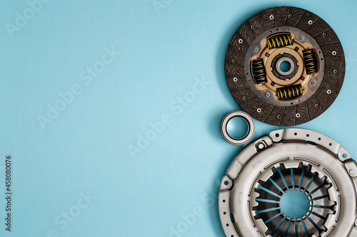 Automotive clutch mechanism, disc, basket and bearing for auto on a blue background.