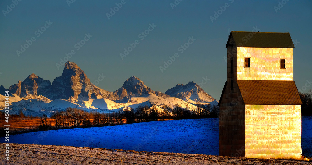 Old Abandoned Grainary Grainery Building with Tetons Teton Mountains in Background