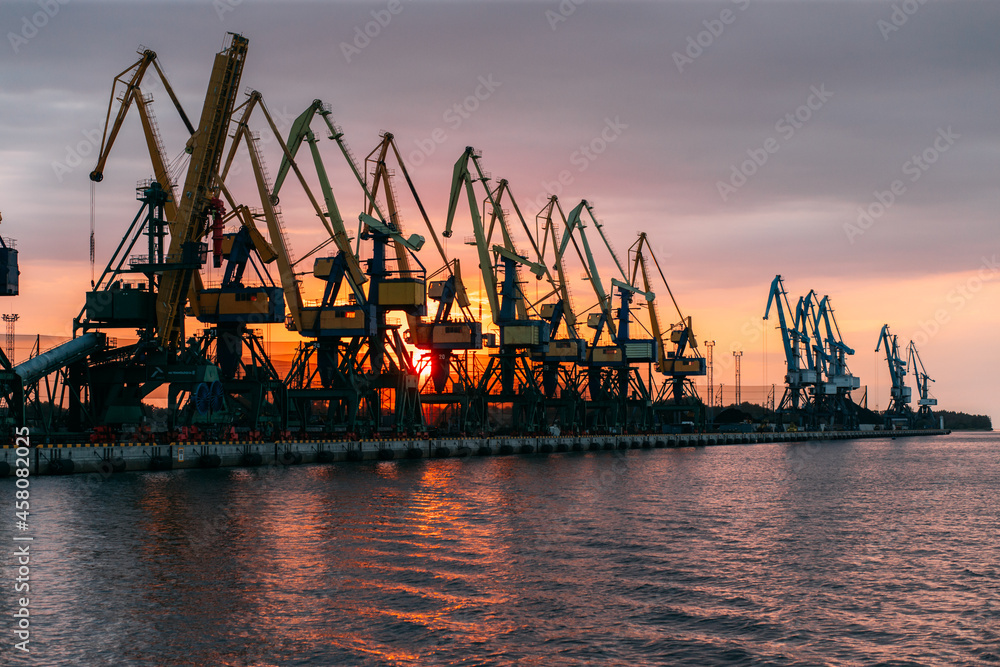 Ship cargo crane port. Container loading industry. Trade and import global transportation by sea ships. Export logistic industry. Cargo sea harbor at evening