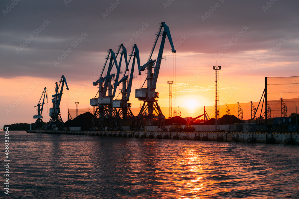 Bulk cargo trade and import global transportation by sea ships. Ship cargo crane port. Container loading industry. Export logistic industry. Cargo sea harbor at evening