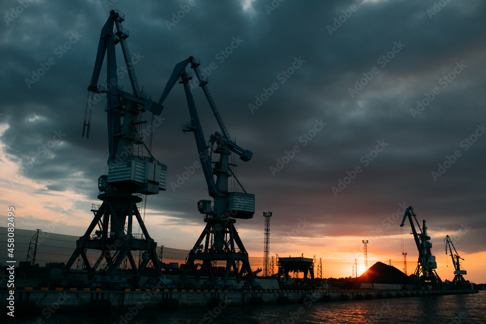 Bulk cargo trade and import global transportation by sea ships. Ship cargo crane port. Container loading industry. Export logistic industry. Cargo sea harbor at evening