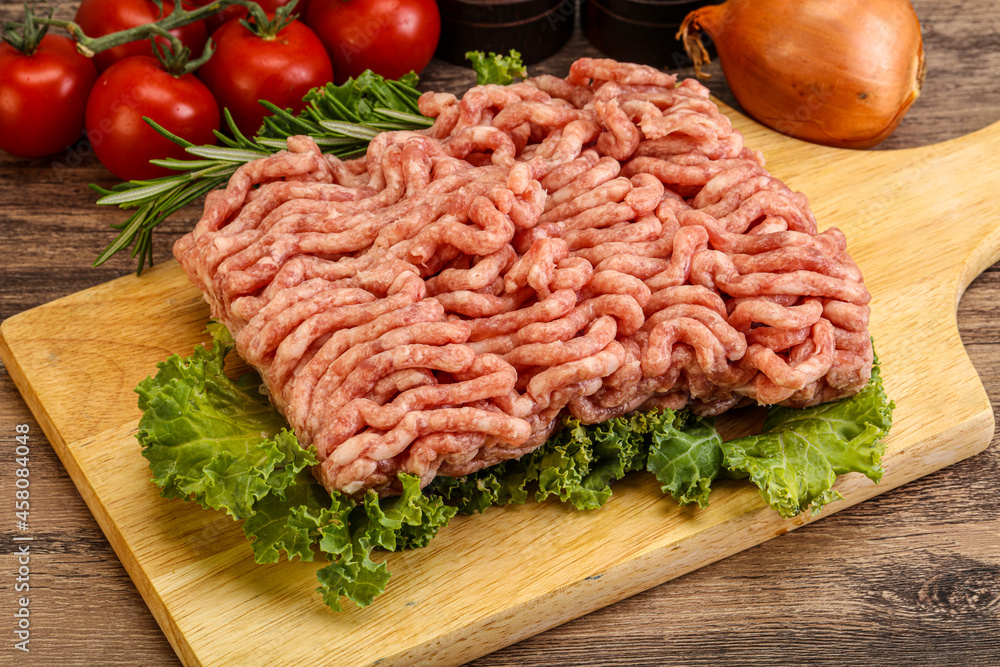 Raw pork minced meat over board Raw pork minced meat over board