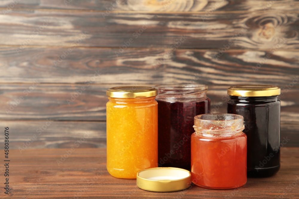Assortment of jams on brown background with copy space. Assortment of jams on brown background with copy space.