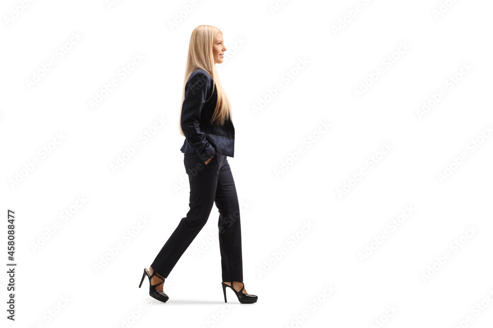 Full length profile shot of a young professional woman with a long blond hair walking Full length profile shot of a young professional woman with a long blond hair walking