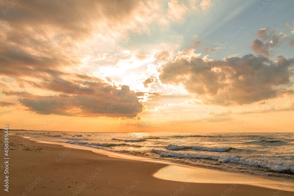 Beautiful sunset over a sandy seaside beach. Baltic Sea (Morze Bałtyckie), Poland. Beautiful sunset over a sandy seaside beach. Baltic Sea (Morze Bałtyckie), Poland.