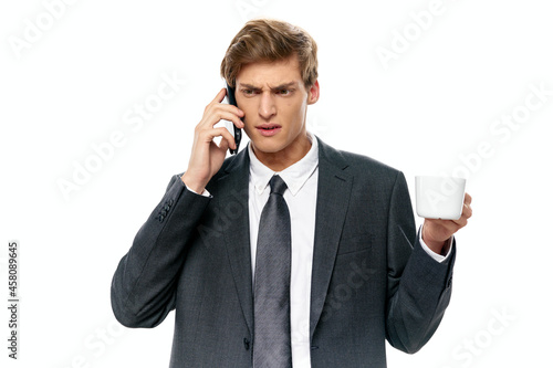 business man in a suit talking on the phone a cup of coffee an official