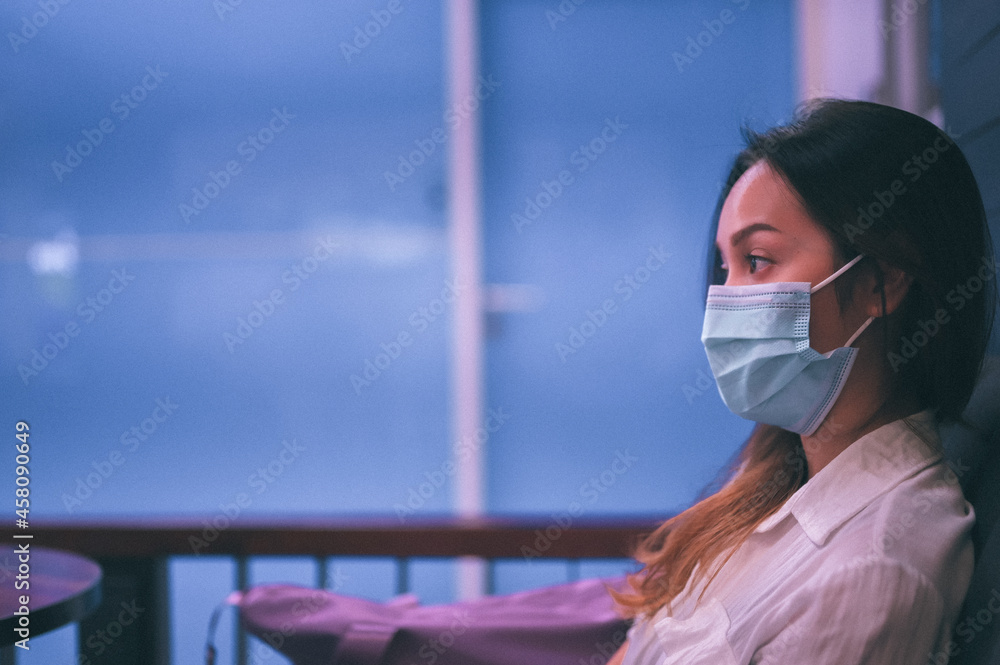 Film grain , Candid side view of young women wearing surgical protection mask be inattentive and waiting something Film grain , Candid side view of young women wearing surgical protection mask be inattentive and waiting something