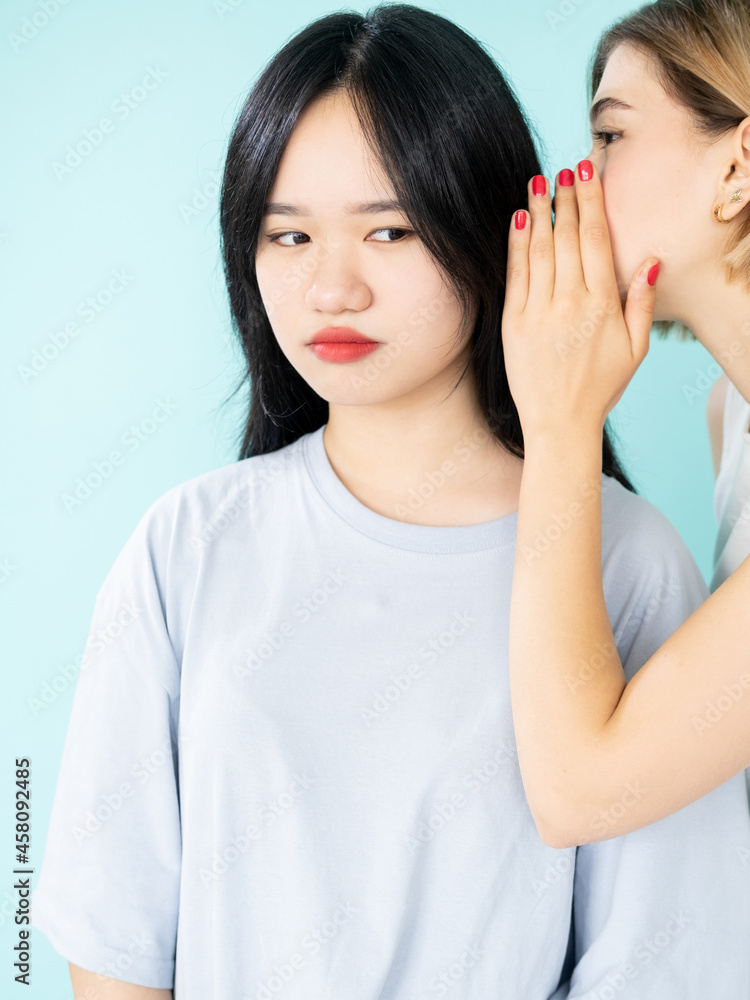 © golubovy - Blaming gossip. Teenager intrigue. Spreading rumors. Conspirator caucasian young women whispering secret information on ear to disbelief asian friend isolated blue. © golubovy - Blaming gossip. Teenager intrigue. Spreading rumors. Conspirator caucasian young women whispering secret information on ear to disbelief asian friend isolated blue.
