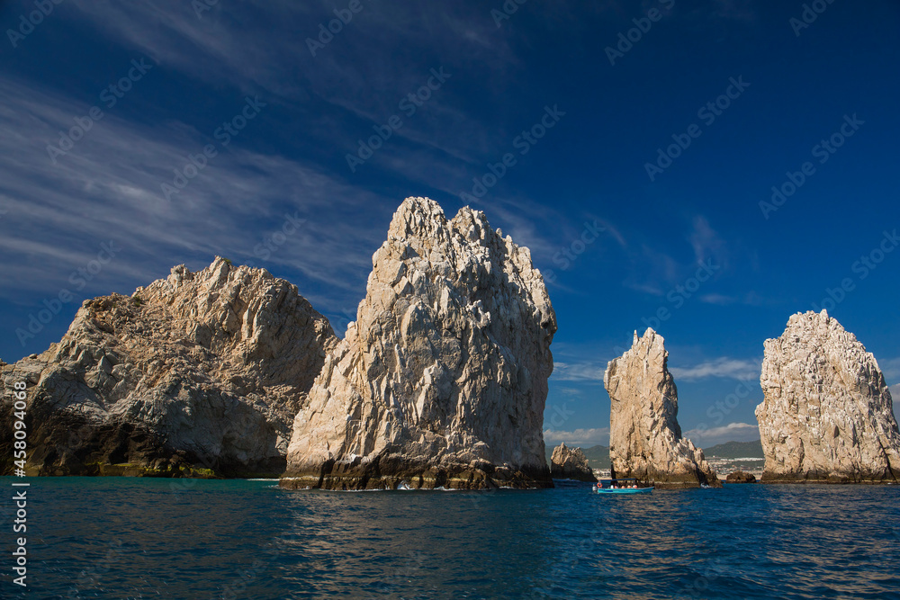 A glass bottom boat takes tourists around rock formations near the Arch in Cabo San Lucas, Baja California Sur, Mexico
