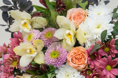 Flower shop concept. Beautiful lovely bouquet of mixed flowers. Roses  orchids  chrysanthemum