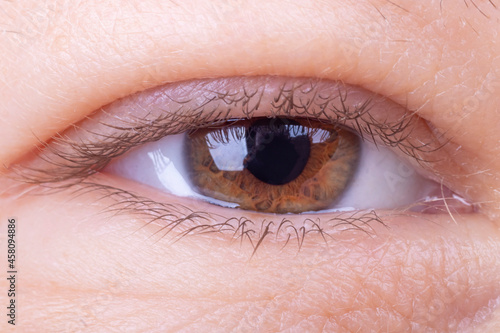 the eye is open. studio lighting. the girl is aged from 30 to 45 years. aging of the skin and eyes. macro. close-up.