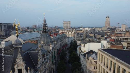 
Aerial drone reveal shot of INNO antwerp department store with golden statue on the rooftop at the shopping street of the Meir in Antwerp photo