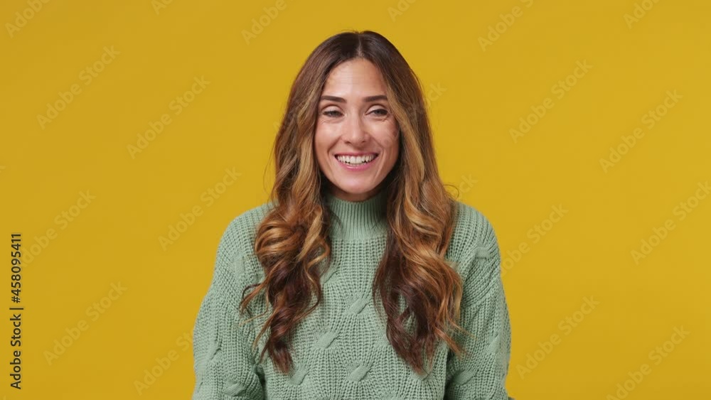 Shocked vivid excited fascinating young brunette woman 30s years old wears mint sweater look camera surprised ask what wow omg no way looking around isolated on plain yellow background studio portrait Shocked vivid excited fascinating young brunette woman 30s years old wears mint sweater look camera surprised ask what wow omg no way looking around isolated on plain yellow background studio portrait