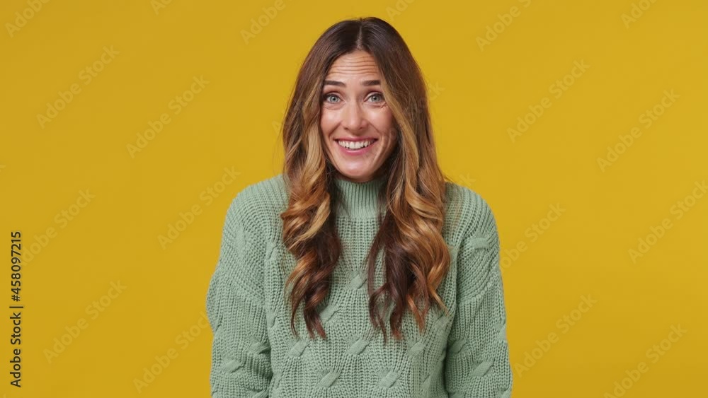 Beautiful smiling stunning fun young brunette woman 30s years old wears mint sweater look camera surprised ask what wow omg no way put hands on face isolated on plain yellow background studio portrait Beautiful smiling stunning fun young brunette woman 30s years old wears mint sweater look camera surprised ask what wow omg no way put hands on face isolated on plain yellow background studio portrait