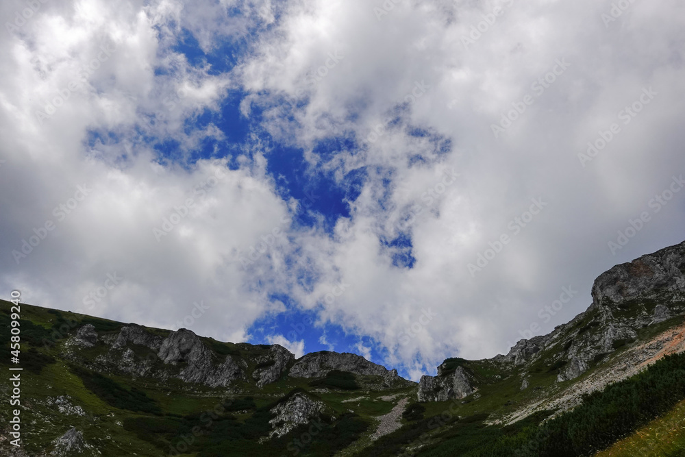 wonderful blue sky with many clouds over a rocky mountain landscape in austria wonderful blue sky with many clouds over a rocky mountain landscape in austria