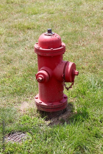 A close view of the red fire hydrant in the grass.