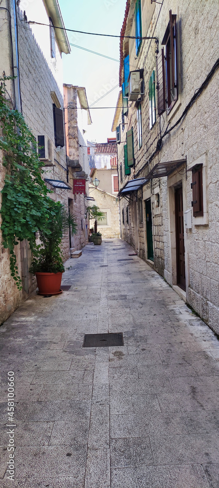 View of a narrow street and stone houses. Historic City of Trogir. Dalmatia. Croatia. Europe	