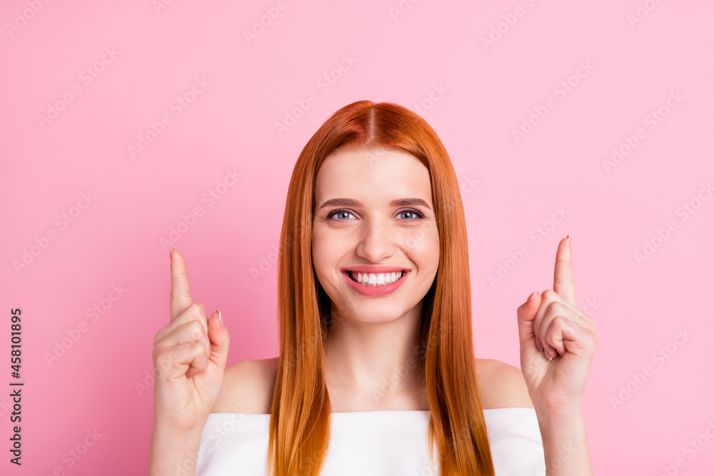 Photo of charming attractive young woman point finger up empty space solution isolated on pink color background Photo of charming attractive young woman point finger up empty space solution isolated on pink color background