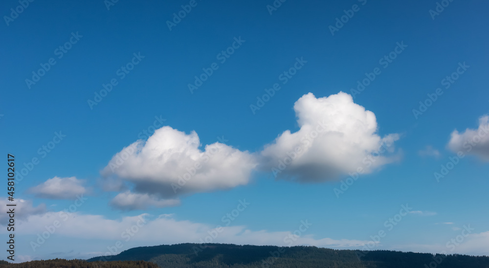 Panoramic View of Puffy White Clouds with Blue Sky during a beautiful Sunny Summer Day. Taken over the coast of British Columbia, Canada. Nature Background Panorama