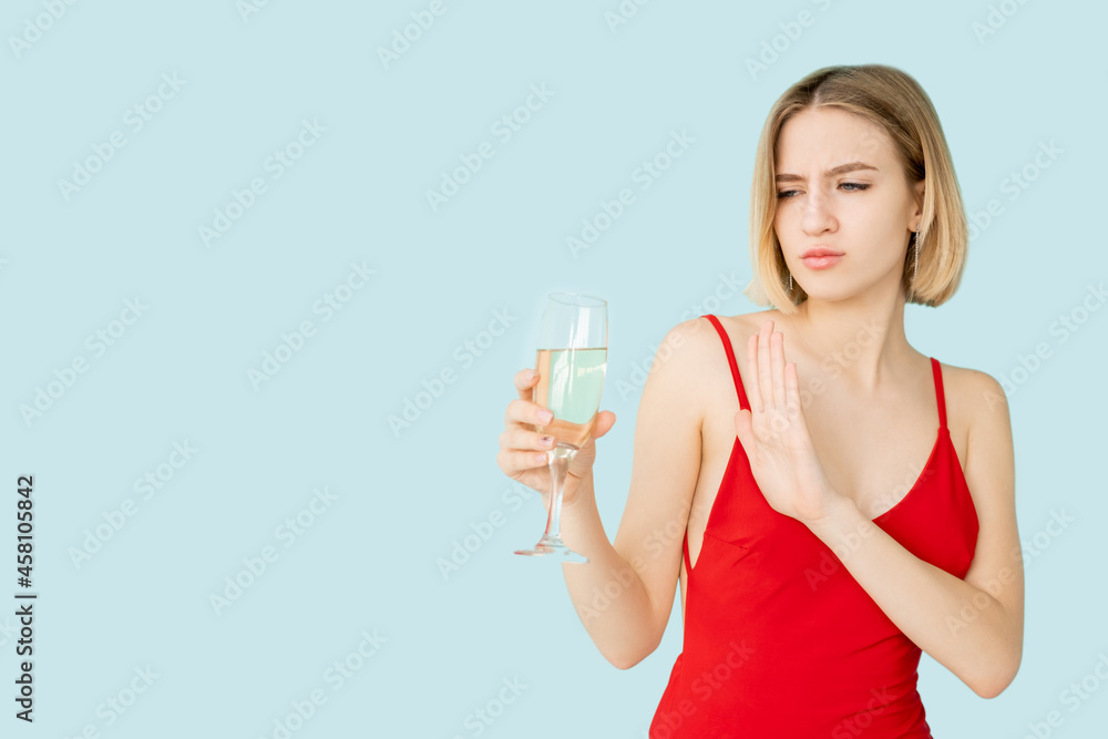 Stop drink. Skeptic woman. Party doubt. Festive celebration. Advertising background. Protesting lady red dress refusing glass of champagne isolated blue copy space. Stop drink. Skeptic woman. Party doubt. Festive celebration. Advertising background. Protesting lady red dress refusing glass of champagne isolated blue copy space.
