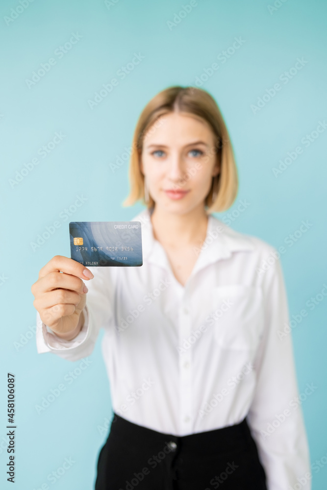 Bank credit. Female officer. Loan rate. Online payments. Best proposition. Happy official woman holding plastic card in hand isolated blue. Bank credit. Female officer. Loan rate. Online payments. Best proposition. Happy official woman holding plastic card in hand isolated blue.