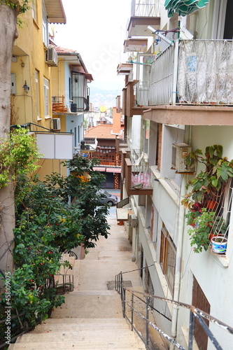 Narrow street in Alanya, steep stairs and balconies with flowers, Turkey, April 2021, cityscape