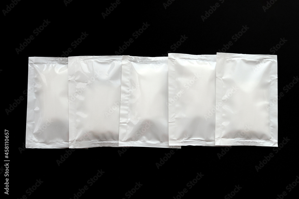 Blank white sachet packets stack mockup isolated on black background ...