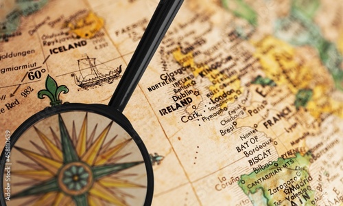 Classic map in a defocused magnifying glass, the theme of travel and trips