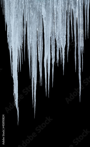 group of long icicles isolated on black background