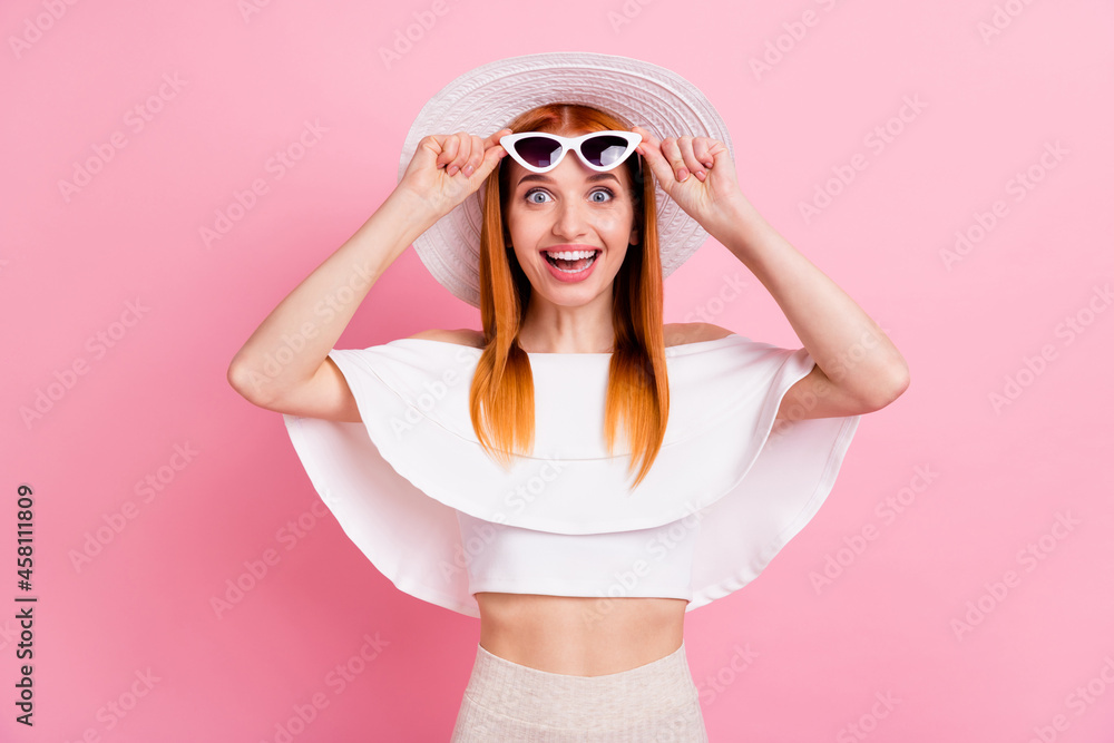 Portrait of attractive amazed cheerful red-haired girl touching specs resort isolated over pink pastel color background Portrait of attractive amazed cheerful red-haired girl touching specs resort isolated over pink pastel color background