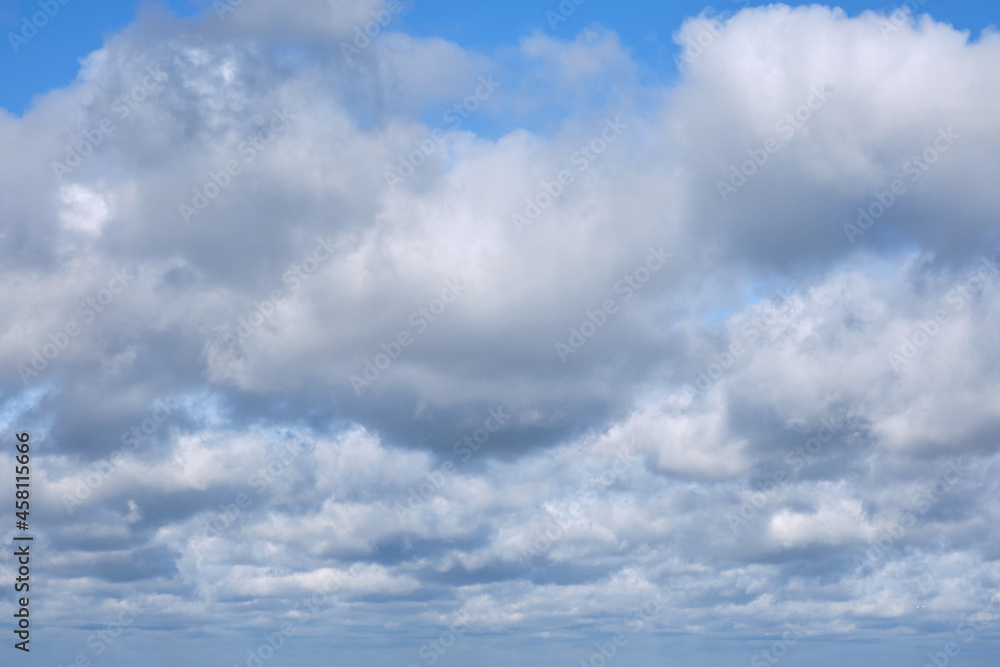 Cumulus clouds against blue sky, background of the copy space