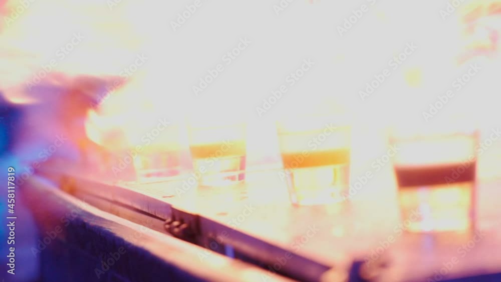 Close-up of a bartender preparing cocktails and setting alcoholic drinks on fire. A night out in a club or a party in a bar. Unrecognizable people. Vertical video. Slow motion. Close-up of a bartender preparing cocktails and setting alcoholic drinks on fire. A night out in a club or a party in a bar. Unrecognizable people. Vertical video. Slow motion.