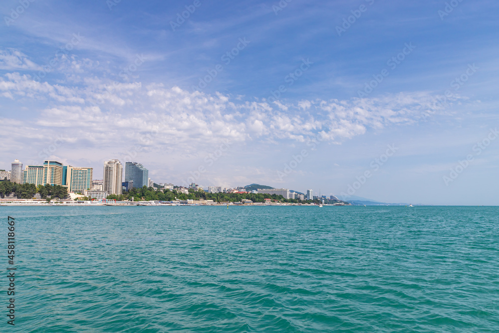 Sochi city coast panorama at summer. View from yacht. Black sea, Russia.