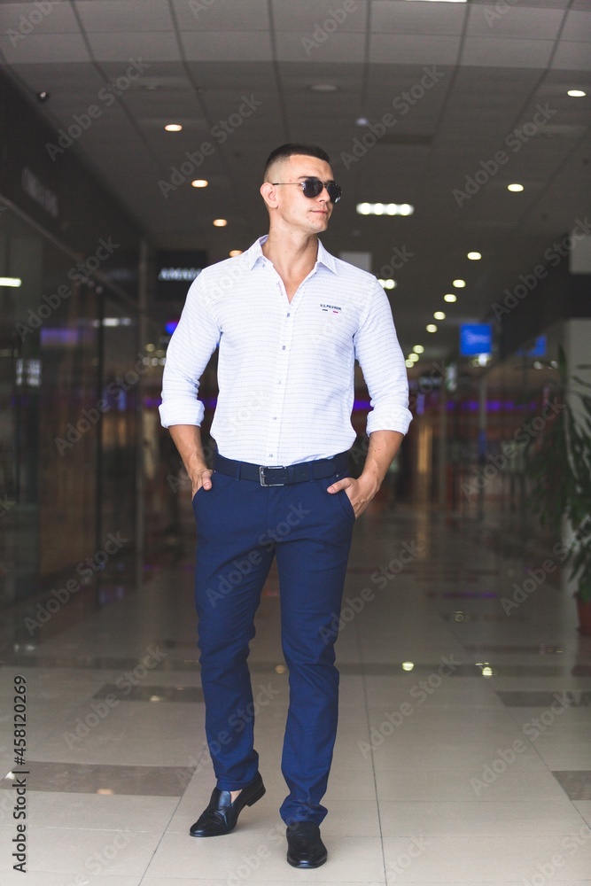 Smiling young man enjoying in shopping background Smiling young man enjoying in shopping background