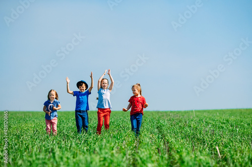 Running kids in green field during summer. © davit85