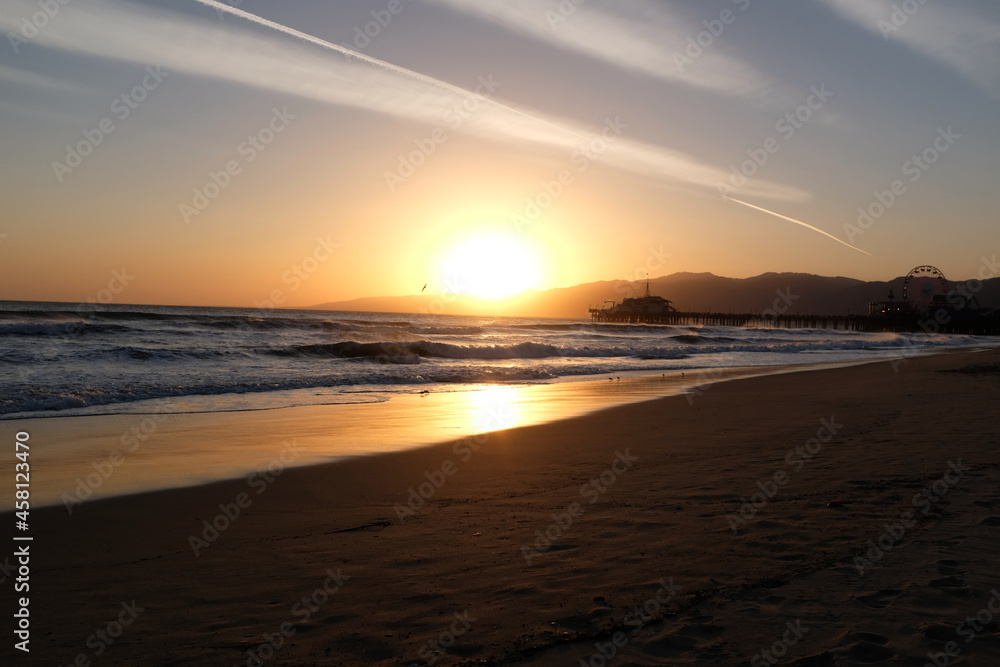 Sunset at Santa Monica Beach, California. The golden color of the sand.