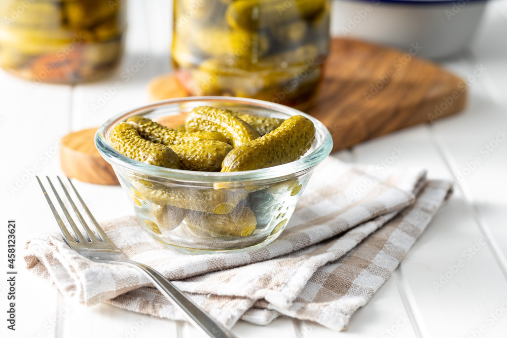 Small pickles. Marinated pickled cucumbers in bowl. Stock Photo Adobe