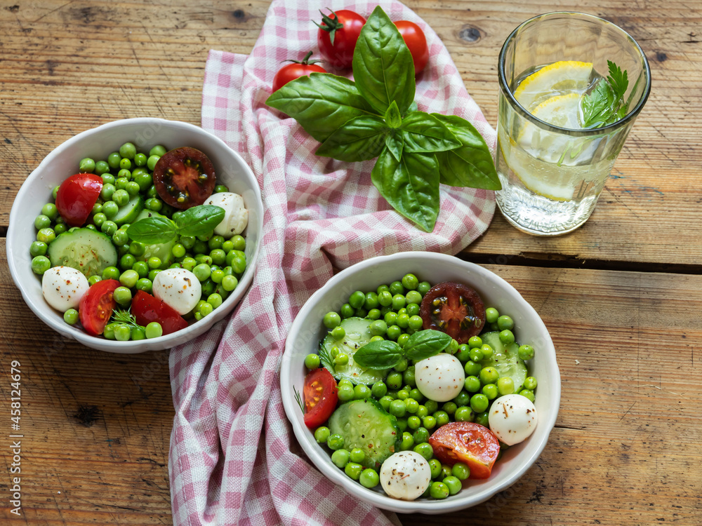 Salad vegetarian. Fresh vegetable salad with tomato, cucumber, basil, green peas, mozzarella cheese. Salad vegetarian. Fresh vegetable salad with tomato, cucumber, basil, green peas, mozzarella cheese.
