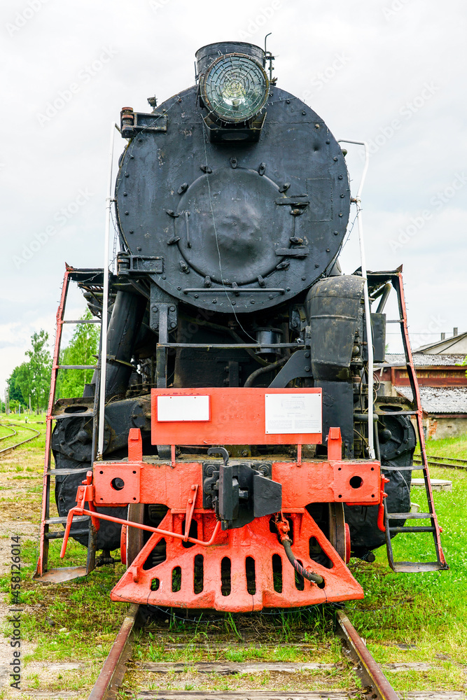 front view of a large black retro steam locomotive