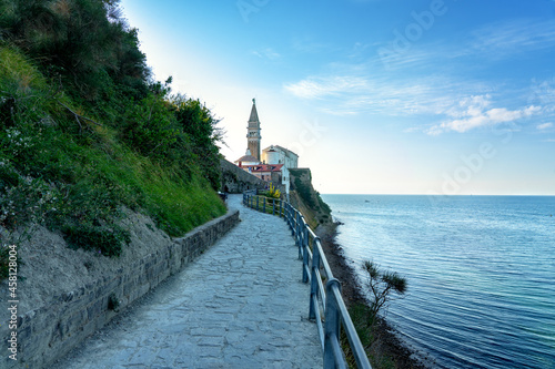 walking path promenade to the saint george church from the beach in Piran