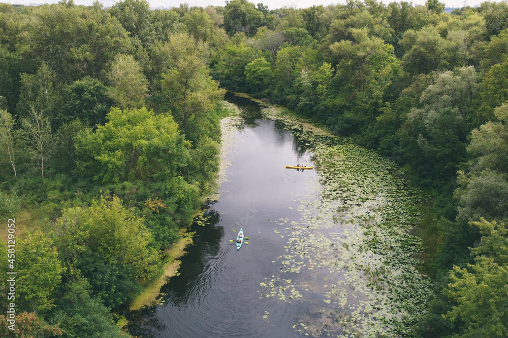 Kayak (canoe) hike across the densely thicket river, along the beautiful views of the river Kayak (canoe) hike across the densely thicket river, along the beautiful views of the river