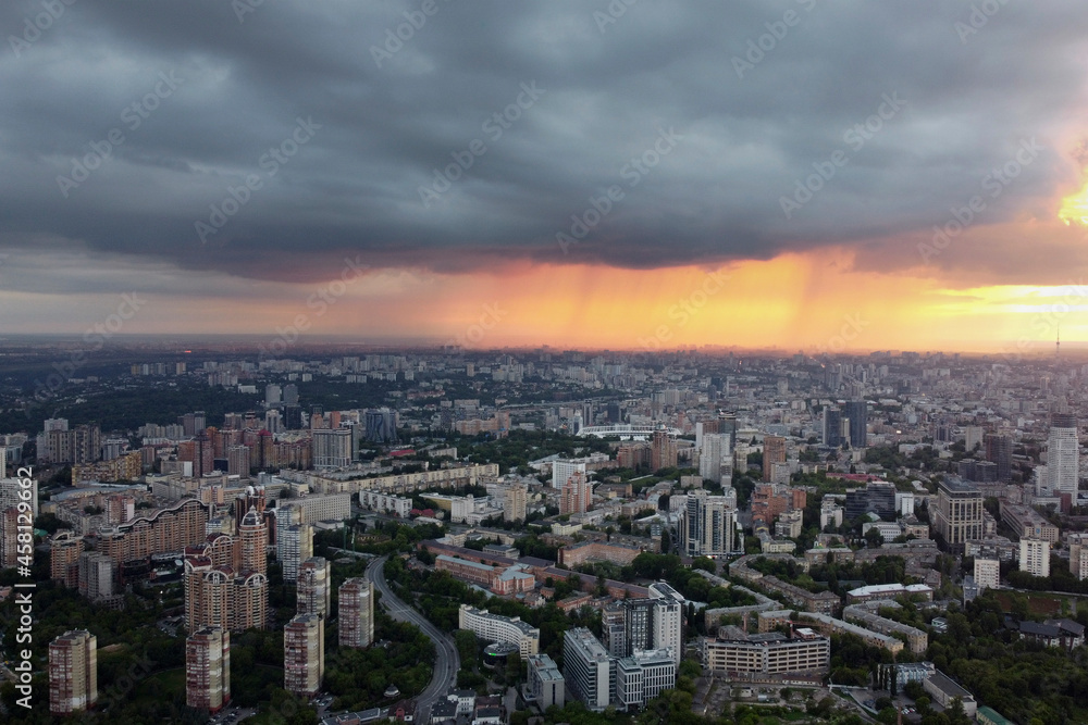 Fototapeta premium Rain in the city Kyiv, drone photo. The photo shows the houses of the metropolis