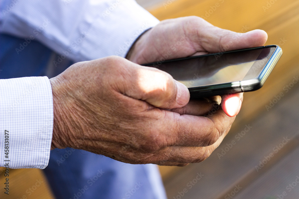 Senior man and his smartphone. Modern mature man have fun using smart phone outdoors Senior man and his smartphone. Modern mature man have fun using smart phone outdoors