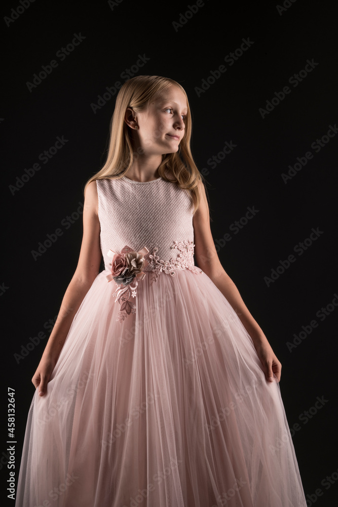 Little beautiful and cute girl child in a fashionable festive dress 