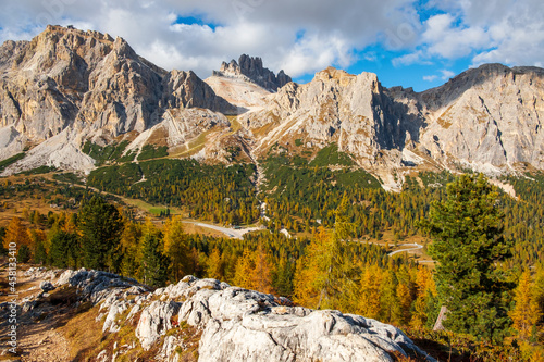 Dolomites, during the day to the Lagazuoi Mountains in the background of the beautiful Pelmo, Averau and Lastoi de Formin mountain peaks, near the town of Cortina d'Ampezzo, in the province of Veneto photo