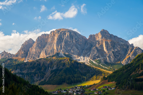 Corvara in Badia charming small Italian mountain village in the valley in the background Sassongher beautiful mountain, Province of Bolzano, Val Gardena, South Tyrol