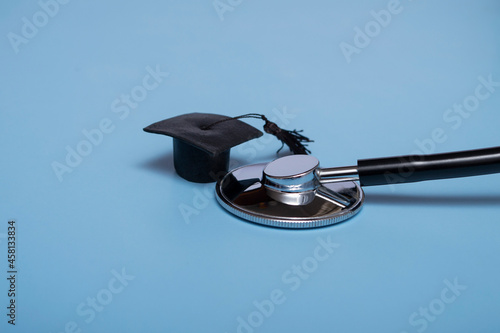 Stethoscope and graduate hat, on a blue background, top view, medical background graduate achievement, background