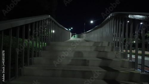 Pedestrian bridge at midnight in Japan. Walking POV
